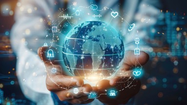 A doctor holds a symbolic globe in his hands, around which various symbols such as a heart and a computer are grouped.